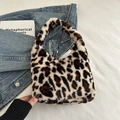 Stylish leopard print faux fur shoulder bag with soft plush texture and integrated handle - White