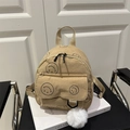 Mini mochila de pana beige con estampado de cara sonriente negra y pompón blanco - Caqui