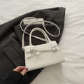 Minimalist white square handbag with bow accent and silver hardware on a blazer - White