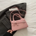 Pink leather square shoulder bag featuring a decorative bow and silver buckle detail - Pink