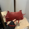 Red crescent shoulder bag in matte faux leather with bow and silver rivet accents - Red