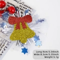 Christmas hair clip featuring golden bells with red bow and white mesh detail - Bell Style