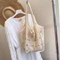 Chic cream woven tote bag with colorful pearl beads for summer beach vacations - White