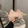 Pink cat-ear crossbody bag with lace bow and cute plush charm in a handheld view - With Pendant / Pink