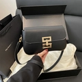 Minimalist black leather crossbody bag with golden geometric lock in premium gift box - Black