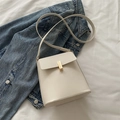 Minimalist creamy white leather crossbody bucket bag with golden buckle on denim jacket - White