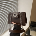 Deep coffee brown leather square bag featuring a sparkling crystal buckle and silver chain - Brown
