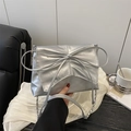 Silver metallic crossbody bag featuring a large bow design and stylish chain strap - Silver