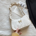 Chic cream white leather shoulder bag with silver butterfly charm and pleated strap - Off White