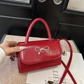 Fashionable bright red square crossbody bag featuring a stylish metallic bow decor - Red