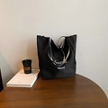 Minimalist black tote bag featuring white mcroi lettering on a walnut wood table - Black Side B (Letter Print)