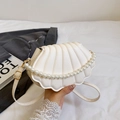 White shell shaped crossbody bag with pearl handle and stylish pleated PU leather texture - White