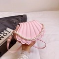 Pink shell-shaped crossbody bag with decorative pearl chain and adjustable shoulder strap - Pink