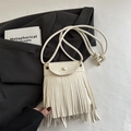 Minimalist beige fringe crossbody bag with textured pebble leather and sleek tassel decor - White