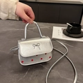 Mini sac argenté à pois rouges avec nœud décoratif et une poignée supérieure élégante - Argenté