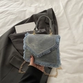 Denim blue crossbody bag with fringe trim, golden chain strap, and V-cut flap design - Blue