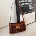 Brown leather shoulder bag with leopard print panel and golden bow detail - Leopard Brown