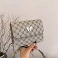 Mini retro geometric crossbody bag in beige featuring a white butterfly buckle detail - Khaki