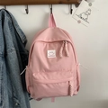 Light pink nylon backpack with smiley face patch and woven rope zipper pull detailing - Pink