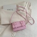 Minimalist small pink square crossbody bag with decorative buckles on a soft blazer - Pink