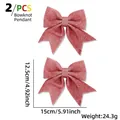Set of 2 red glitter Christmas bow pendants with 15x12.5cm dimensions on white background - Pink