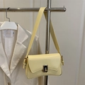 Minimalist pale yellow leather crossbody bag with golden twist lock and wide shoulder strap - Yellow