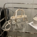 Cream bucket bag with grey butterfly prints and a decorative pearl bow charm - With Pendant / White