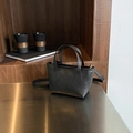 Minimalist black pebble leather bucket bag with top handle and crossbody strap - Black