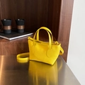 Vibrant lemon yellow leather bucket bag with top handles and cross-body strap - Yellow