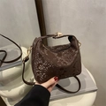 Dark brown faux snakeskin cloud bag with golden buckle and adjustable crossbody strap - Brown
