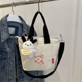 Cream canvas crossbody bag with cartoon bear print and black straps for daily wear - With Ornament / Black