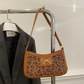 Brown leather baguette shoulder bag with leopard print panel and gold bow buckle - Caramel color