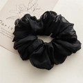 Close-up of a large black ruffled chiffon scrunchie with layered translucent fabric - Black
