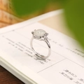 Close-up of S925 silver Hetian jade square ring with butterfly carvings on a book - Adjustable Open / White Jade Style