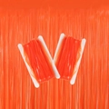 Fluorescent macaron orange party fringe curtains neatly wrapped on cardboard rolls - Neon Macaron Orange Red