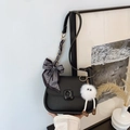 Black matte saddle bag with striped silk scarf and white plush keychain ornament - With Pendant / Black
