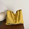 Fashionable bright yellow tote bag with pleated texture and black brand lettering - Yellow