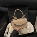 Beige crossbody bag with unique knotted handle and gold hardware in premium gift packaging - Khaki