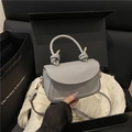 Light blue-grey crossbody bag with knot handle and gold hardware in a premium gift box - Gray