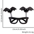 Halloween Partybrille mit schwarzen Glitzer-Fledermausflügeln und flauschigen Pompon-Augen - Einheitsgröße / Schwarz