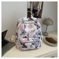 Close-up of white floral backpack featuring colorful butterfly patterns in a lifestyle setting - Flower Butterfly