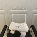 Minimalist white PU leather underarm bag with silver bow accent and curved top edge - White