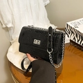 Glossy black crocodile-embossed flap crossbody bag with silver chain and metal lock - Black