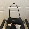 Minimalist black baguette bag with silver bow accent and adjustable shoulder strap - Black