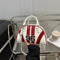 Red and white retro shell handbag with embroidered 96 and star rivets in city setting - White