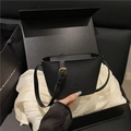 Minimalist black lychee texture leather bucket bag with gold hardware and shoulder strap - Black