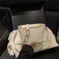 Minimalist white lychee leather bucket bag with gold hardware and logo branding - White