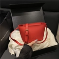 Chic red bucket bag in lychee pattern leather with adjustable strap and gold buckle - Red