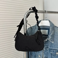Minimalist black crescent shoulder bag with a ruffled cloud strap and cute bow detail - Black