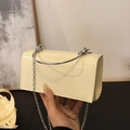 Chic beige textured crossbody bag with silver metal ring handle and chain strap - Light Yellow